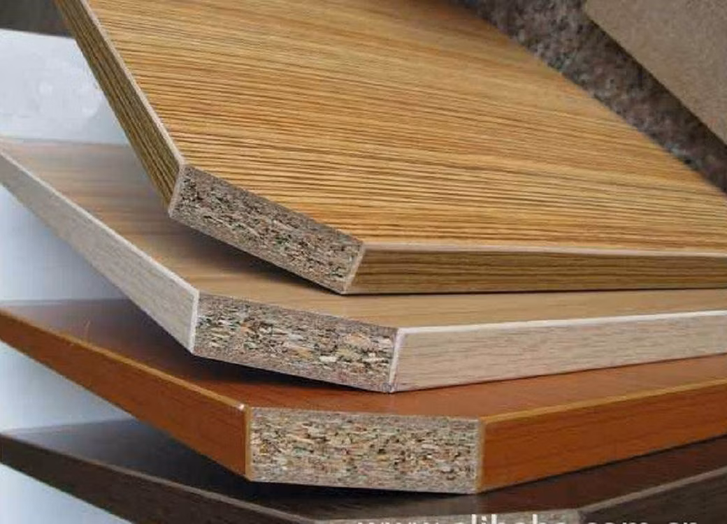 Close-up of particle board edges showing wood particles.