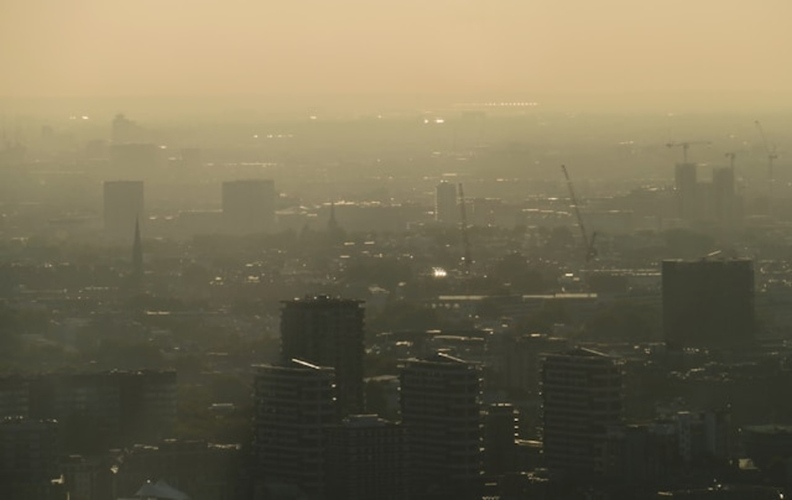 Aerial view of urban cityscape with visible pollution highlighting the need for sustainable cities and climate action