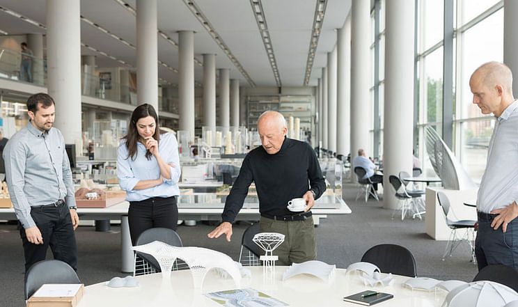 Intern participating in project meeting with senior architects.*