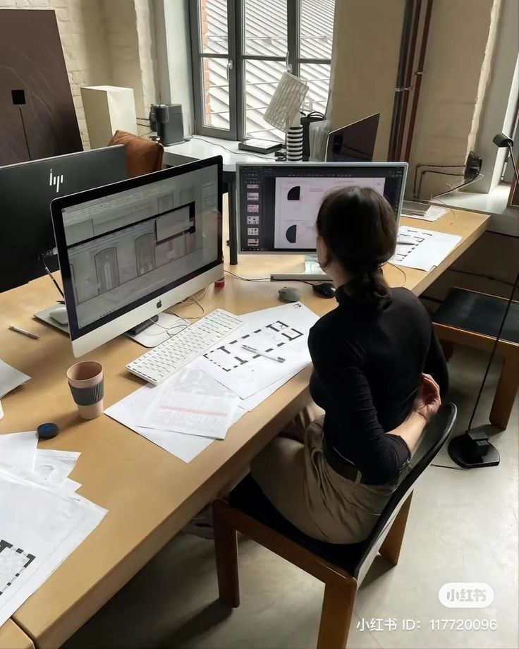 Intern using AutoCAD and Revit on dual screen workstation.*
