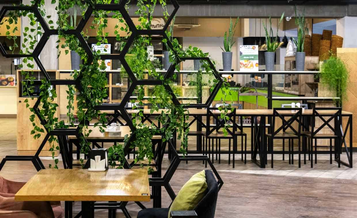 Interior space designed with hexagonal ceiling pattern promoting spatial connectivity