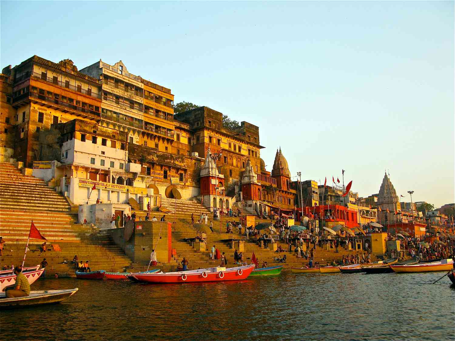 The image captures the vibrant riverfront scene at Varanasi, where urban life thrives. 