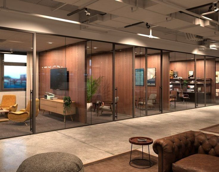 Modern commercial office interior with polished flooring, modular furniture, and glass partitions.