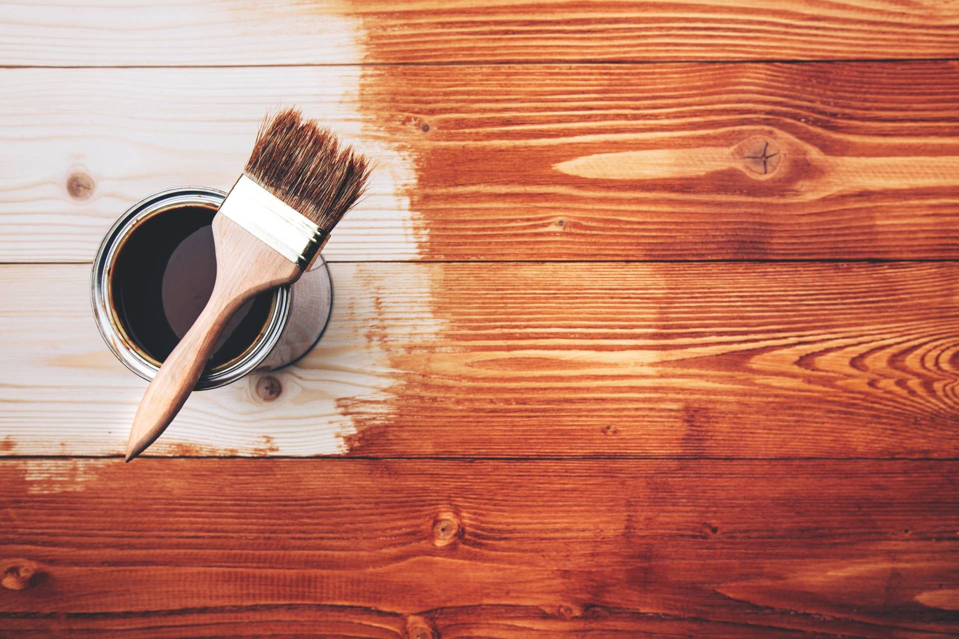 &nbsp;Interior wood panel treated with dark walnut stain, showing grain texture.*