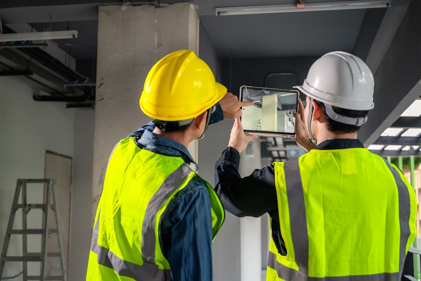 Site architect inspecting building work at construction site.