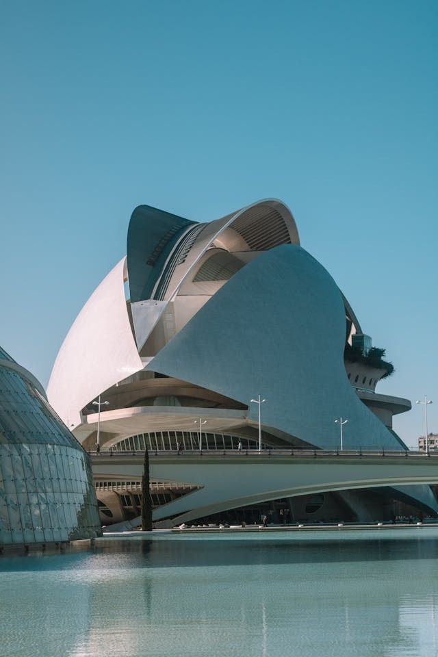 A modern, futuristic building with sweeping curves and metallic surfaces, showcasing the innovative use of parametric design