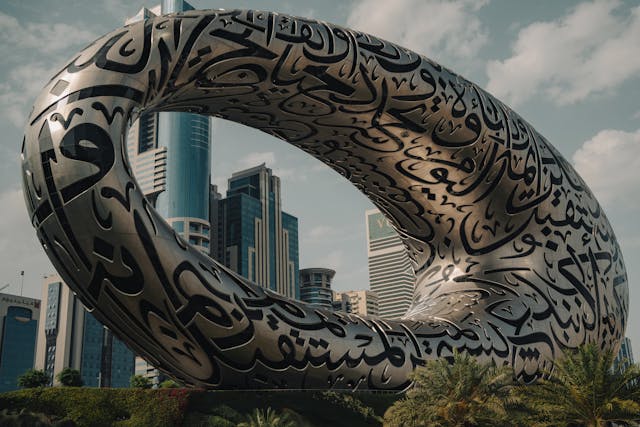 A modern, parametric building with an oval shape, showcasing intricate script designs.&nbsp;