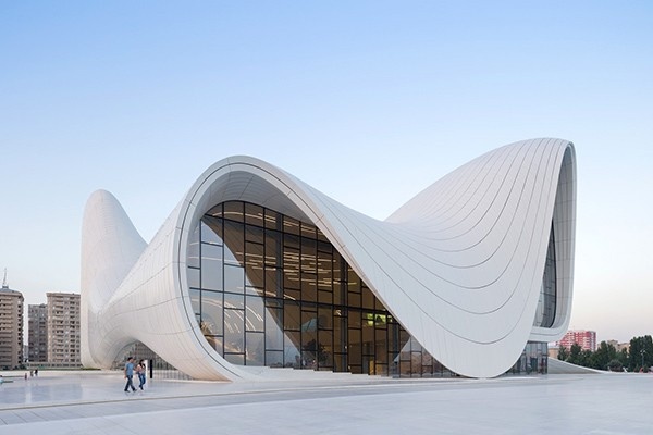 Heydar Aliyev Center in Baku featuring futuristic fluid architecture with sweeping curves and glass facade.