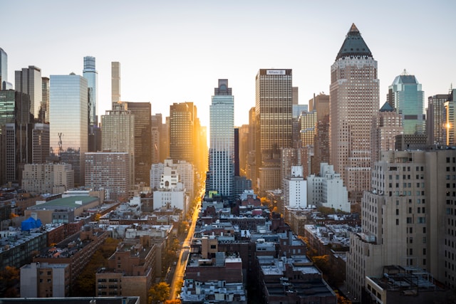A cityscape of tall buildings at sunset. 