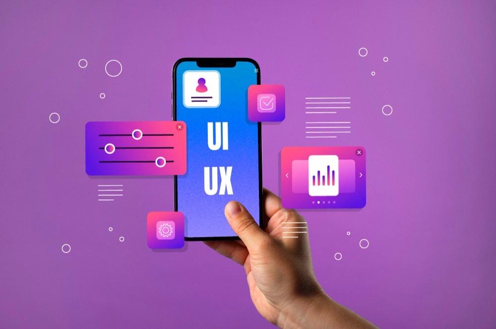 A hand holds a smartphone with a blue screen displaying "UI UX." Surrounding the phone are colorful icons representing settings, data analytics, and user interface elements against a purple background, illustrating the principles of UI-UX design and visual hierarchy.