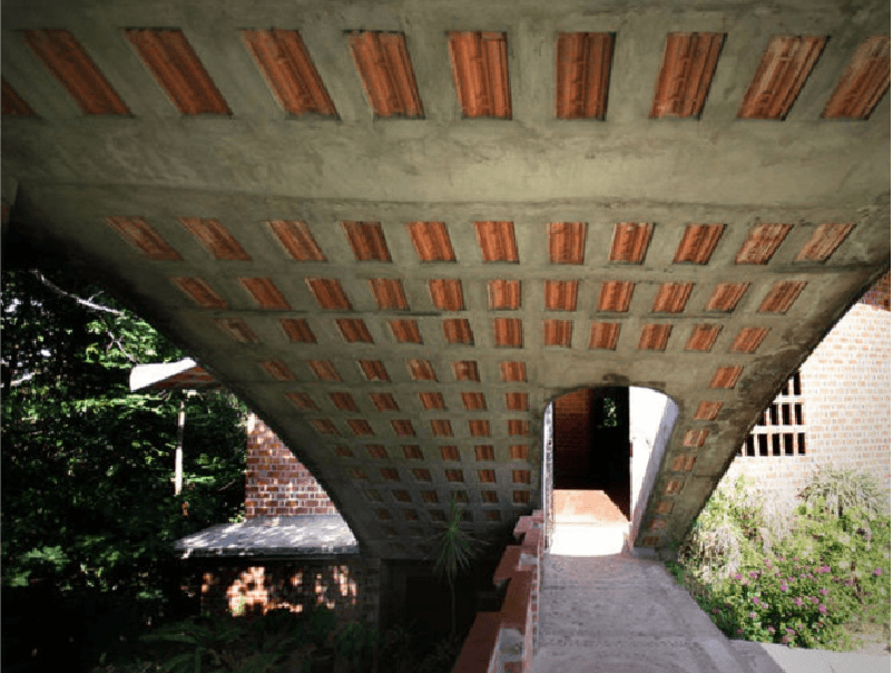 Roof Extending to shade a bridge between two buildings at one of the laurie baker campuses.
