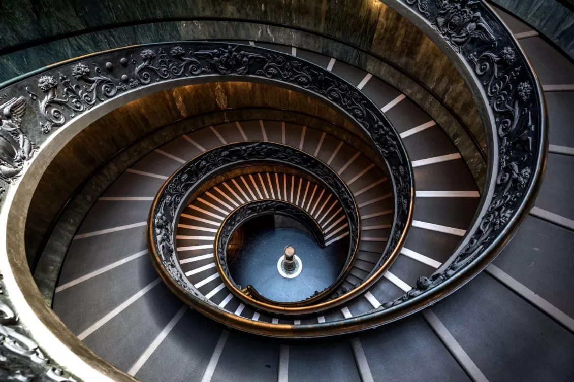 A stone spiral staircase winding clockwise inside a medieval castle tower