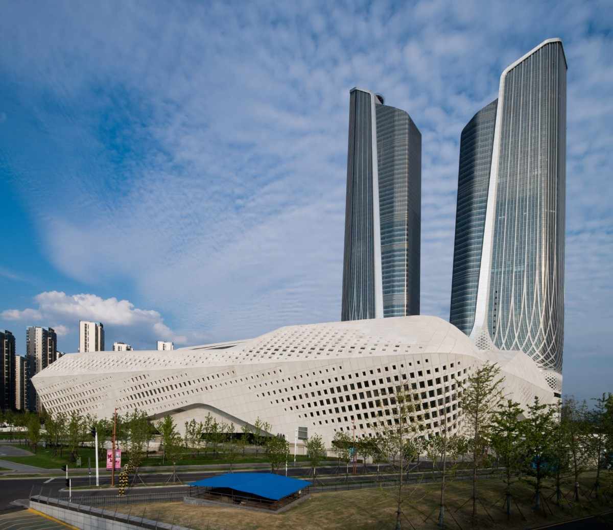 Exterior view of the Nanjing International Youth Cultural Centre, showcasing its futuristic twin towers and curvilinear base structure designed by Zaha Hadid Architects